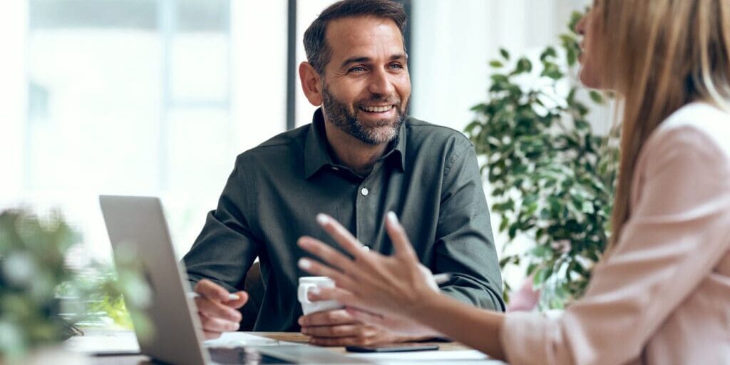 Smart business people working together with laptop while talking